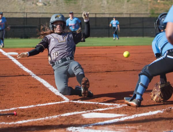 softball player sliding into home plate at brenau univeristy's softball complex