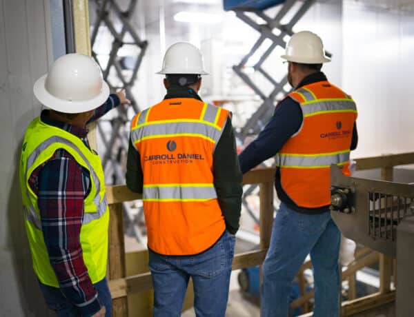 three carroll daniel workers watching over construction site